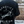 Black Dog Bone t-shirt with 'GENETICS over AESTHETICS' and 'Belgian Malinois' design on the back, worn by a person.